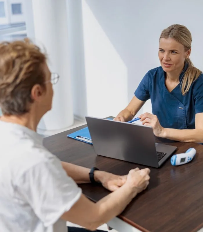 A smiling doctor filling out a medical report