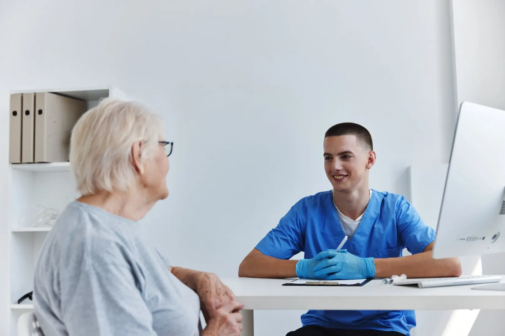 An older patient talking with a doctor during a consultation