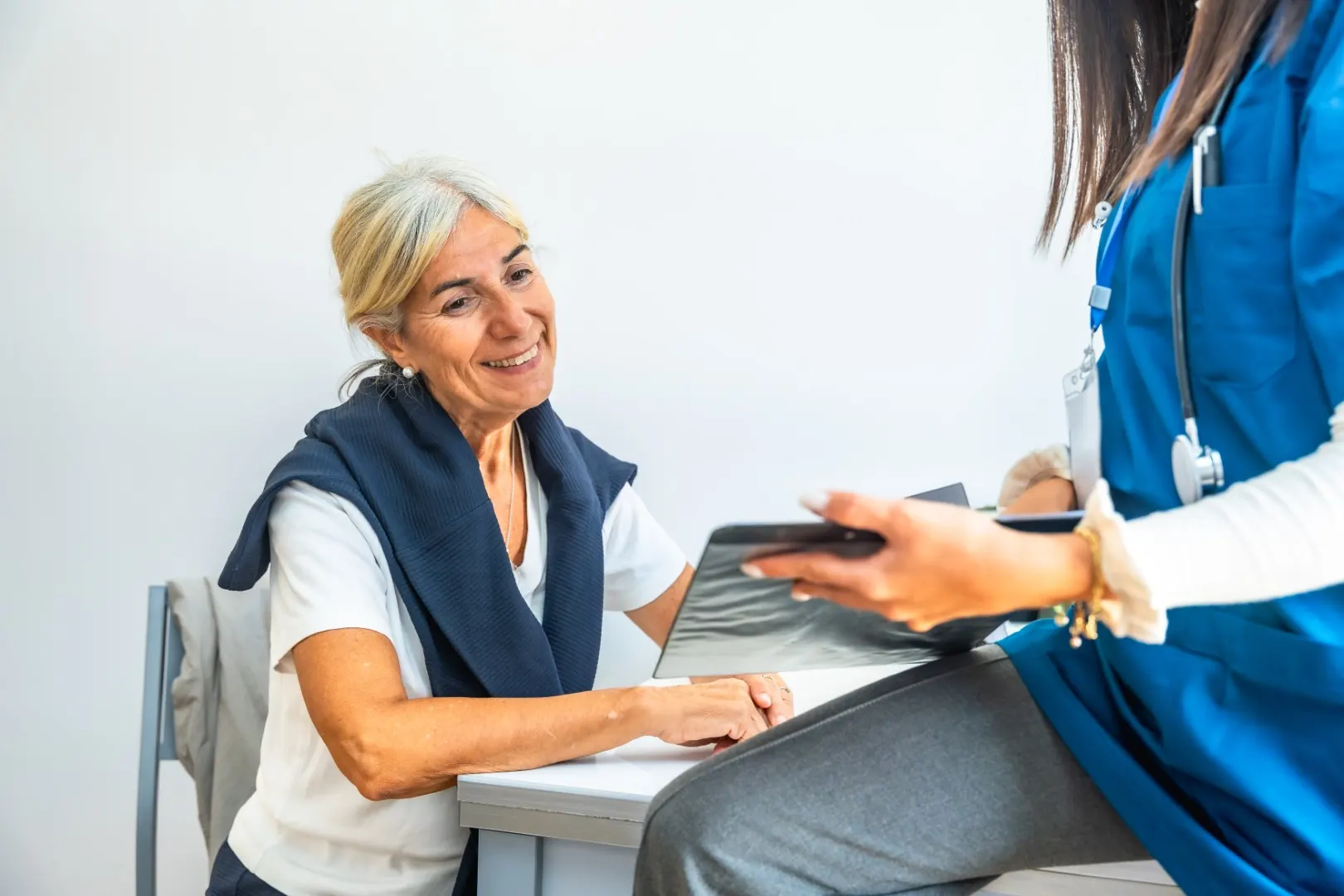 A senior woman smiling during a medical consultation