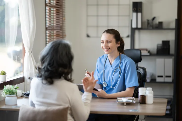 Female doctor explaining diagnosis to her old patient.